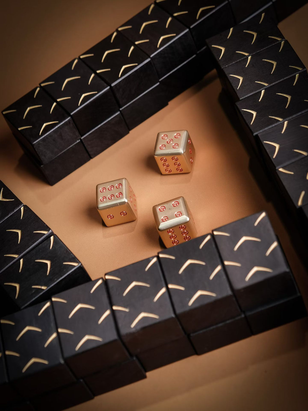 Dark wooden mahjong tiles arranged around dice